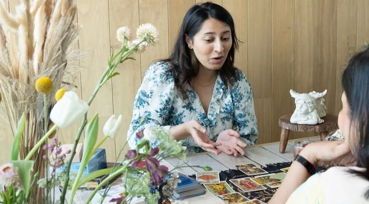 A horizontal view of a serene space with tarot cards and journaling